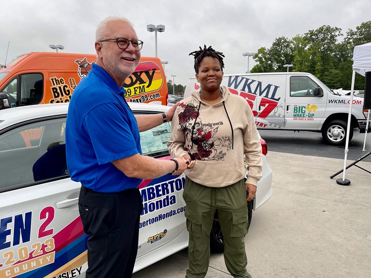 Kent Locklear of Lumberton Honda presents Keonna Love with her new car at Driven 2 Excel 2023